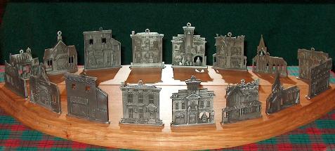Pewter Christmas Building Display with mirror showing backside of ornaments